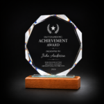 Personalized crystal achievement award trophy with laser engraving, multi-faceted crystal design, and elegant wooden base for corporate recognition and employee awards.